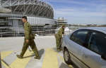 Soldiers check a parked car